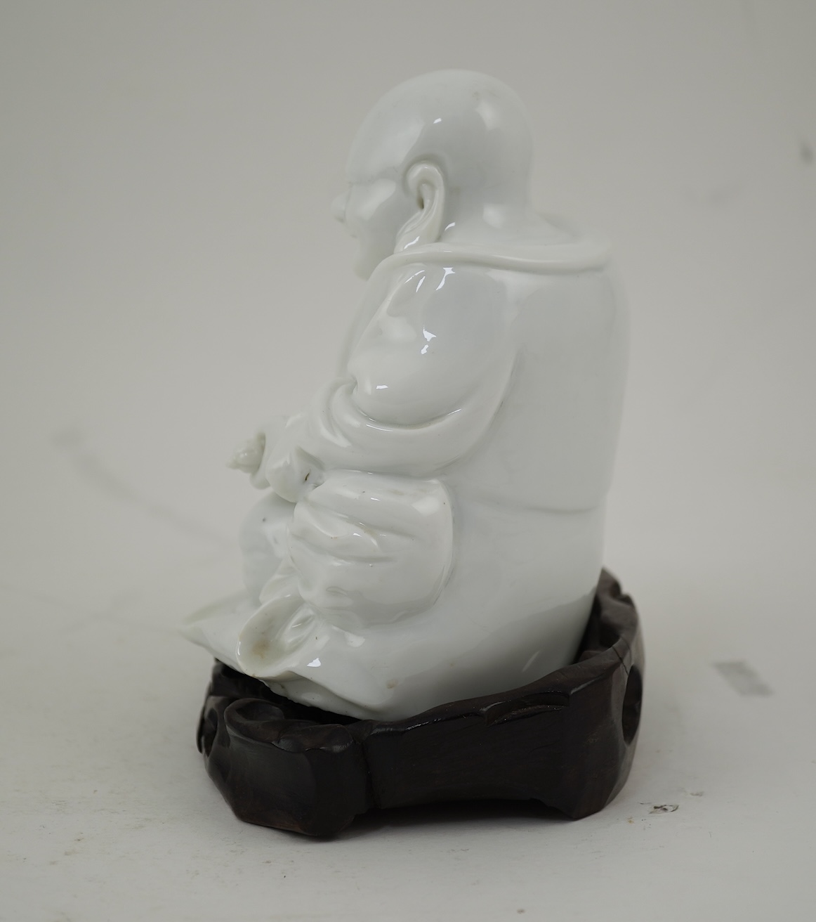 A Chinese blanc-de-chine seated figure of Budai, 18th/19th century